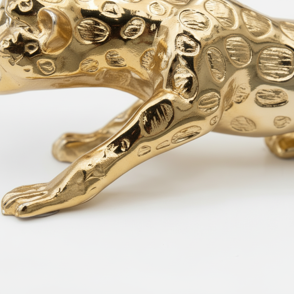 Gold leopard figurine paws body texture close up